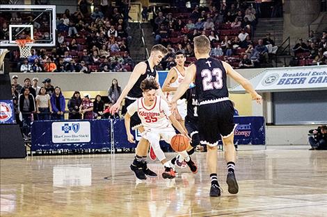 Greg Whitesell slips through Manhattan Christian Eagles players.