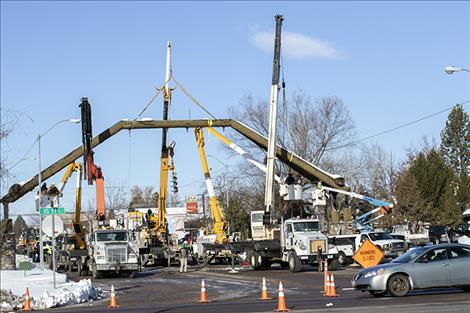 A crew takes down the Ronan arch on Main Street. 