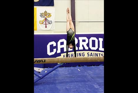 Lauren Collinge competes on the beam. She finished third in both the balance beam and the vault.