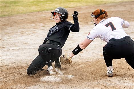 A Lady Broncs base runner narrowly slips past the tag of Maiden Emilie Corley.