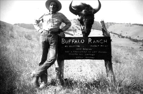 Ike Melton stands beside his ranch sign.