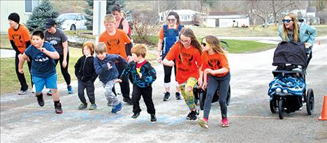 Children and adults take off for the fun run.   