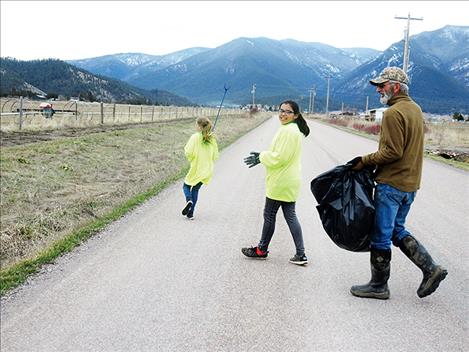 Toni Hadley, Dvaiah Gasco and another volunteer clean up trash on Jocko Road.