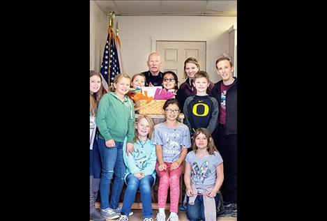 K. William Harvey Elementary students bring a gift basket to the Ronan Police Department.