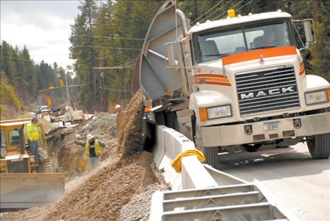 In 2008, workers dump fill dirt along Montana Highway 35 where nearly 6,380 gallons of gasoline spilled into the ground and leached into fresh water sources.