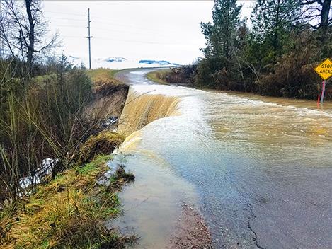 Water spills over Dublin Gulch Road on April 10 before the road washes away. 