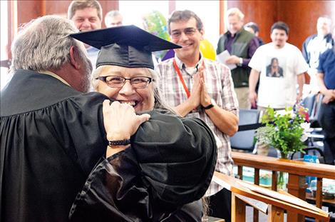 Susan Pierre gives Judge James Manley a hug during her graduation ceremony from Lake County Drug Court.