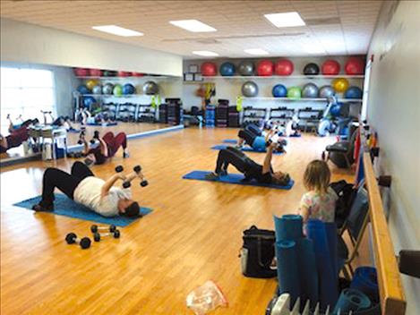 Folks participate in an exercise class at the aquatic center.