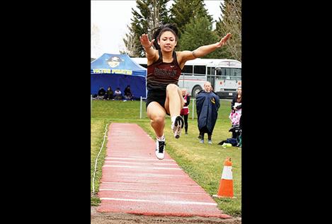 Mission Lady Bulldog Tiana Ulutoa leaps through the air at a track and field event in April.