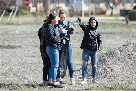 Ronan students show care for their community by picking up trash around town on last Friday's sunny but windy day.