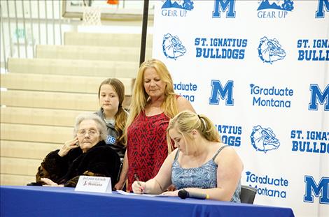 Jolynn Girch signs an intent to go to college.