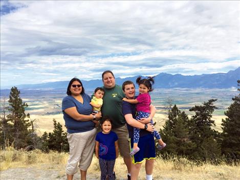 Tribal Health Medical Director Bernadette Corum, stands with her husband and four children.