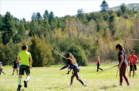 Children play a game of double ball to learn  respect for all things. 