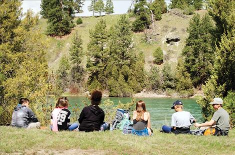  Jon Gustafson's fifth-grade class sits by the river during lunch.