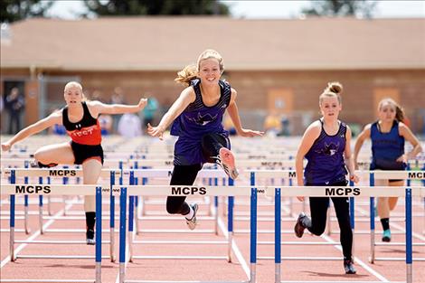 Charlo Lady Viking Carlee Fryberger races to a first place 100-meter hurdle finish.