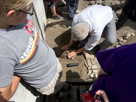 Lt. Gov. Cooney plants a bitterroot, Montana's state flower, with Polson Middle School students to mark the occasion. Middle school students alone saved eight tons of recyclables from going to the landfill.