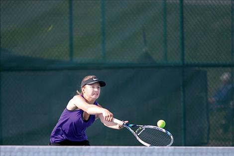 Lady Pirate Shea McGuinness taps the ball over the net for a point.