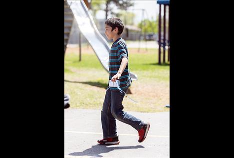 Pablo Elementary fourth-grader Daniel Santos walks back to his seat with a broken egg.