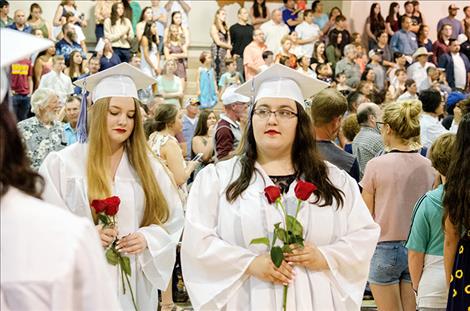 Graduates give roses to people who supported them during high school.