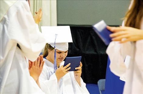 Allyson Sherrill holds  her diploma.       