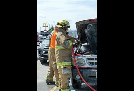 Ronan Volunteer firefighters respond to a car fire in the Ronan Harvest Foods parking lot.  