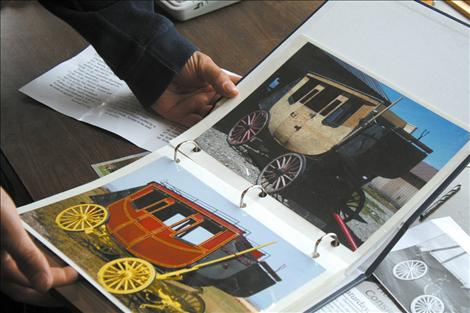 Marvin Troyer holds some before-and-after photos of some of his recent work. Carriages like these will be up for auction during the first-annual Horse Progress Days.