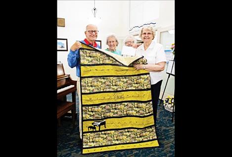 To thank him, residents recently presented Bob with a quilt they made for him. Pictured from left are: Bob McClellan, Anne Edwards, Donna Cason and Velma Madsen. Ed Burrows (not pictured) also helped make the quilt.