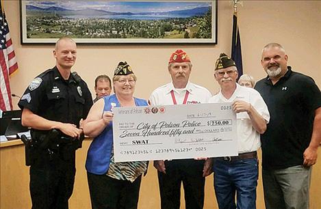 The favor is returned to the police department as veterans present money for training.