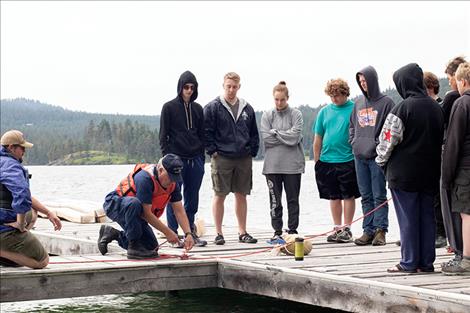 Flotilla Commander Kyle Boyce instructs future lifeguards on proper knot tying techniques.