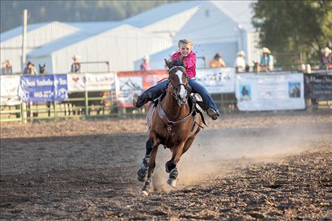 Junior barrel racer Blair Lytle of Ronan races to the finish line.