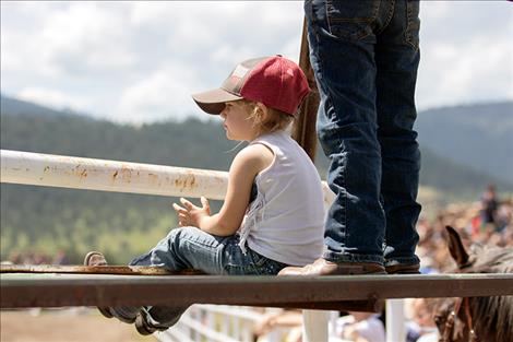 A young rodeo fan enjoys the show.