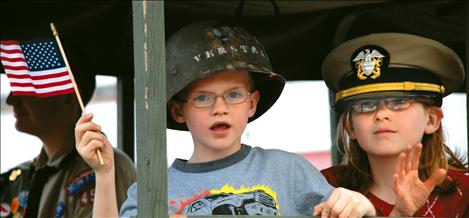 Colton Pieper and Kaitlynn Lamphere ride in the Freedom Truck, a WWII-era six-top troop carrier, in Polson’s Memorial Day Parade.