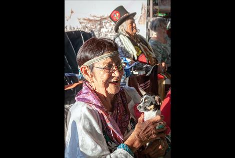 Elder Rachel Bowers holds her dog during the annual celebration.