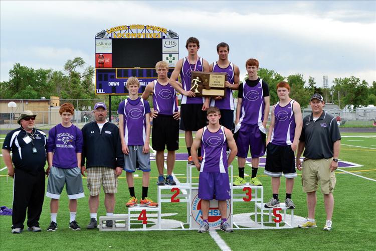 Members of the Charlo High School boys State champion track team include Jacen Petersen, front. Back row, left to right: Coach Jim Petersen, Michael Delaney, coach Bret Thompson, Dalton Delaney, Connor Daugherty, Webb O’Neill, Tra Ludeman, Kail Pope, Tyler Delaney, coach Jared Miller. Not pictured: Coach Mike Krahn (because he was taking the  photograph).