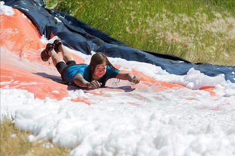 Ash Cardoza slides headfirst into a big batch of bubbles.