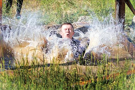 A competitor splashes down during the sixth annual Polson Mud Run at the Polson Fairgrounds on Saturday morning.