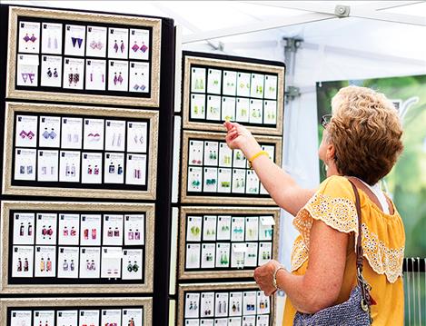 Festival goers browse jewelry  among other custom artwork.