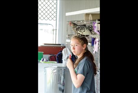 Shawnte Erickson hangs out with a chicken.