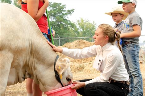  Gabby Smith gives Moose a drink.