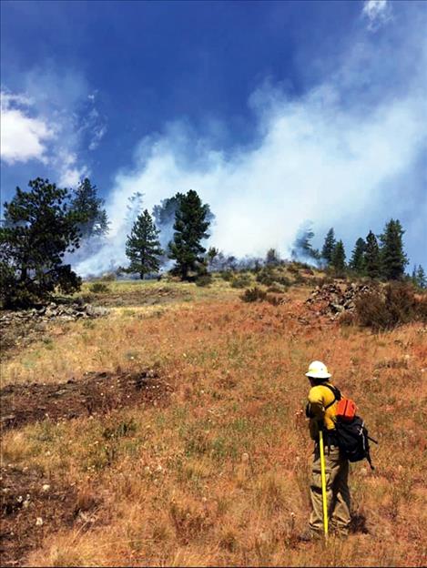 A firefighter monitors the controlled burnout.