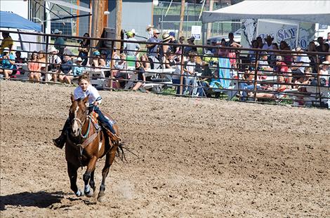 Barrel racers take a turn in the arena.