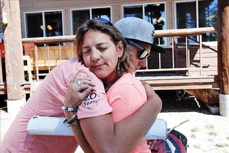 Grief Camp Director, Tina Barrett, receives a bear hug from teen leader, Jakob Beich. Beich has  attended A Camp to Remember since 2009 following the death of his father. Barrett founded A Camp to Remember in 1997.