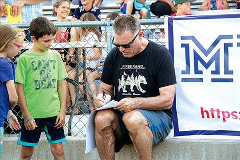 NFL Hall of Famer and Super Bowl Champion Oakland Raider Howie Long signs a few autographs for young fans. Long was the surprise guest at last week's meet-and-greet barbeque event.