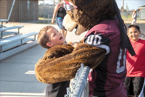 A youngster receives a big bear hug from Monte.