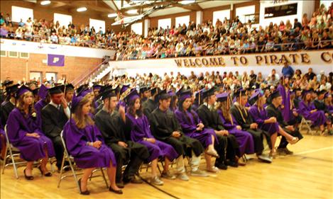 Polson High School graduates of the class of 2013 listen to commencement speeches during Saturday’s ceremony at Linderman Gymnasium.