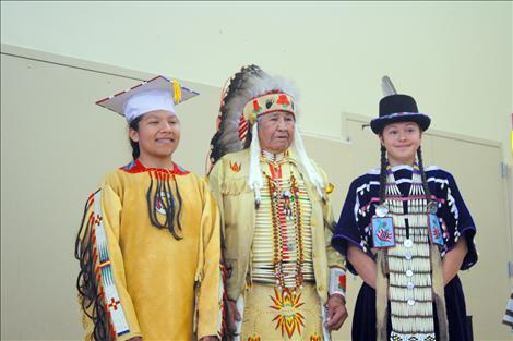 Perry and Sandoval stand proudly next to head Nkwusm instructor Pat Pierre a few moments before the graduation powwow began.