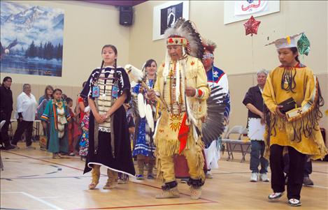 Daniel Martynowicz/Valley Journal Elder Pat Pierre leads recent graduates Nicole Perry and Mars Sandoval through the Arlee Community Center with friends and family in tow.