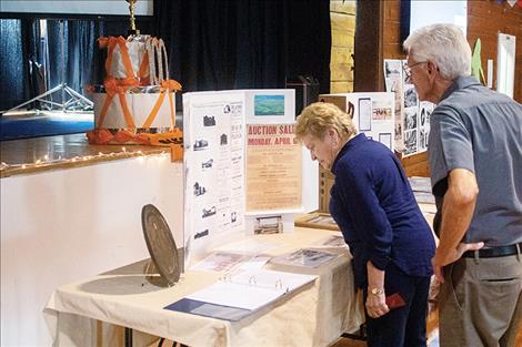 Celebration attendees look at articles and  memorabilia from the Dixon School. 