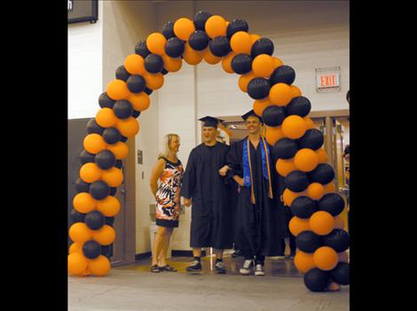 Valedictorian Robert Hocker enters the gymnasium alongside fellow graduates.