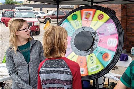 A child takes a spin on the free prize wheel.